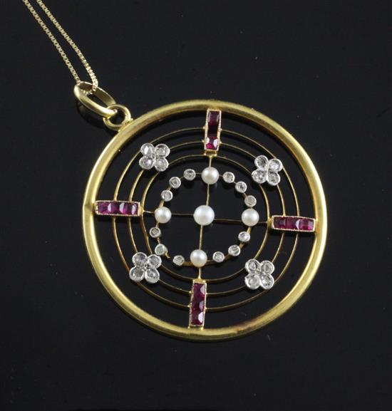 A mid 20th century gold, rose cut diamond, ruby and seed pearl set circular openwork pendant, 34mm.